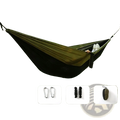 Lightweight camping hammock in camouflage black and olive green fabric suspended between trees in outdoor setting