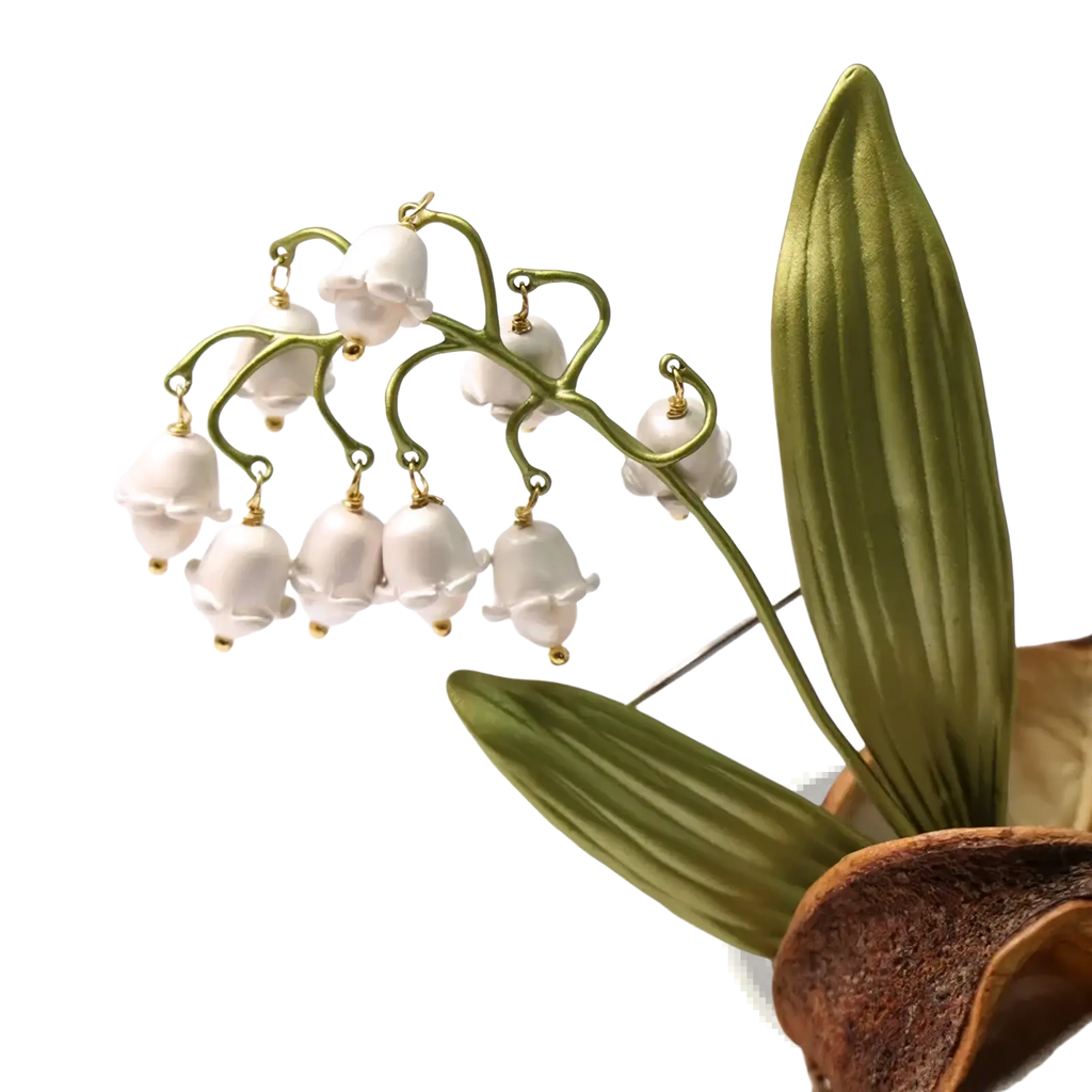 Delicate white lily of the valley pearl brooch pin with gold-toned metal stems and leaves for elegant accessorizing
