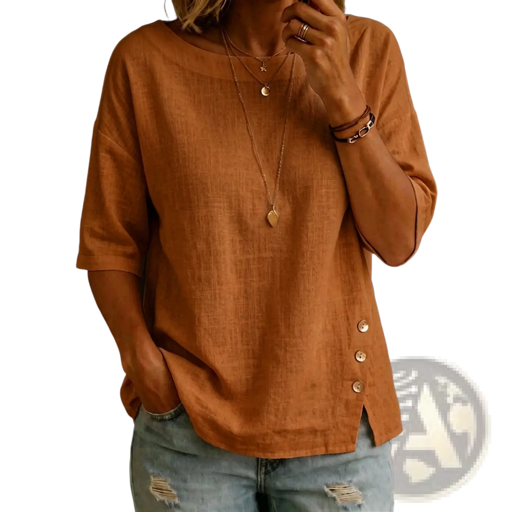 A soft rust-colored linen asymmetrical button casual top with three-quarter sleeves and a relaxed fit