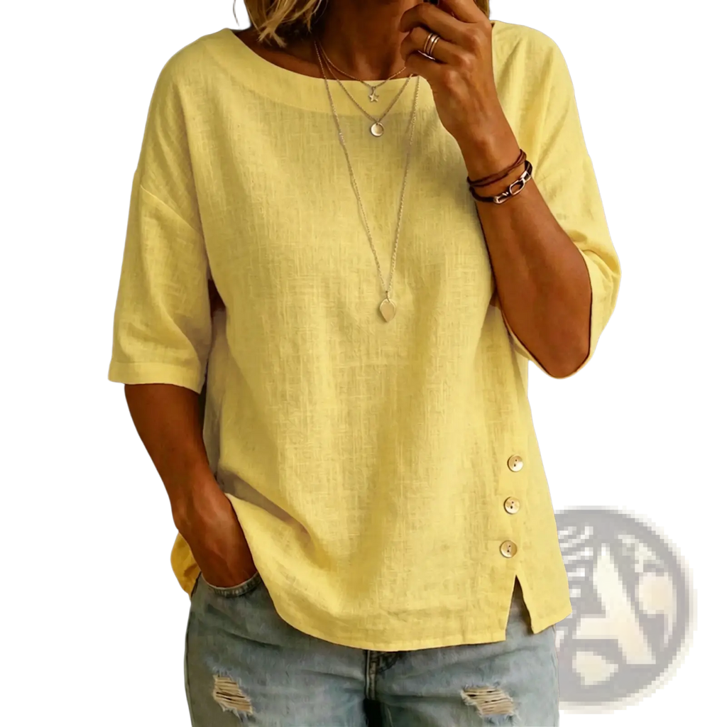 A soft yellow linen asymmetrical button casual top with three-quarter sleeves and side button detail