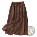 A flowing brown linen midi skirt with an elastic golden drawstring waistband for casual wear