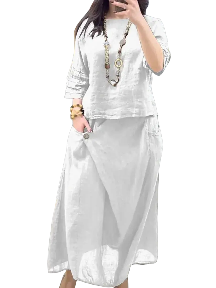 White linen two piece set featuring a loose casual blouse and flowing midi skirt with delivery protection time benefits