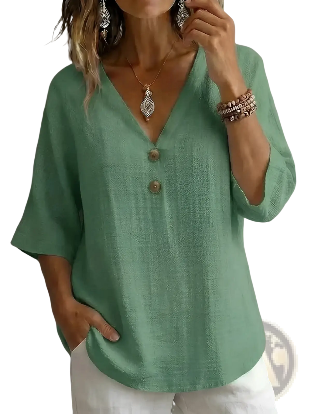A soft sage green linen v-neck button top featuring three wooden buttons down the front