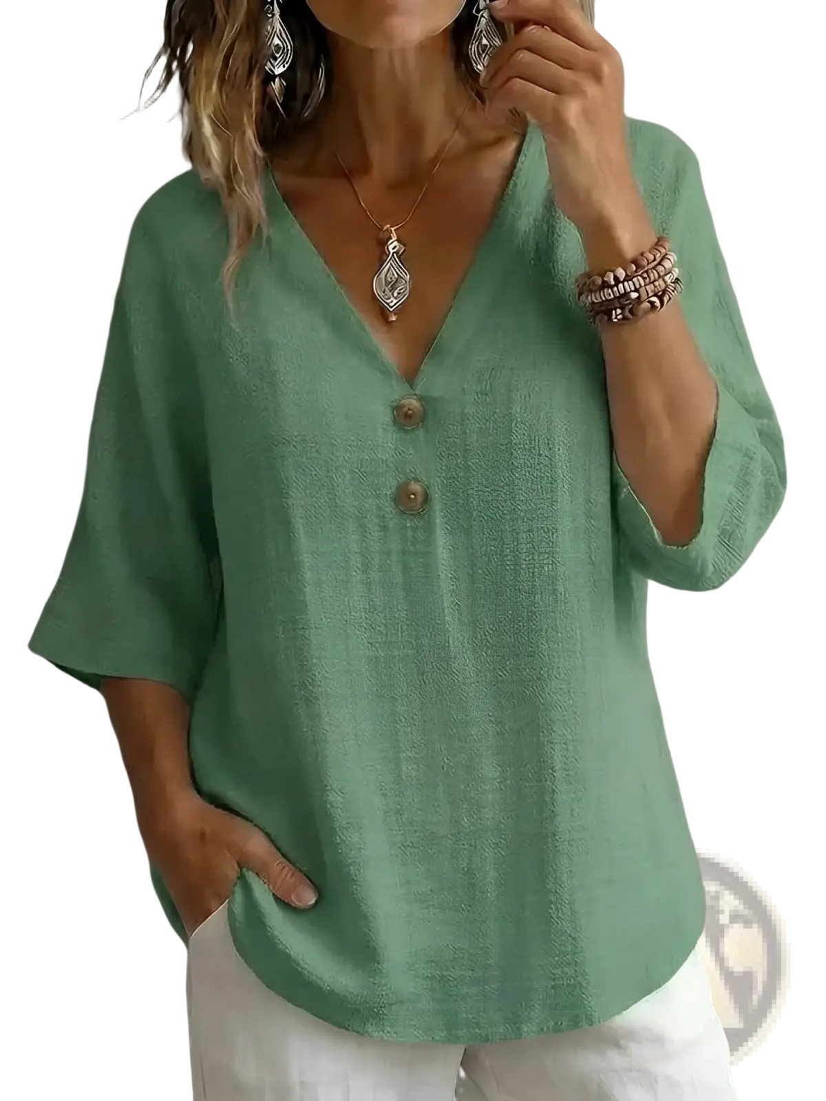 A soft sage green linen v-neck button top featuring three wooden buttons down the front