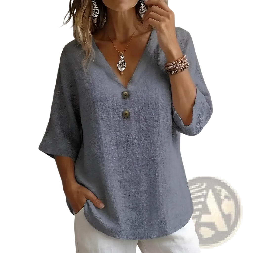 A soft light gray linen v-neck button top with three-quarter sleeves ideal for casual and formal wear