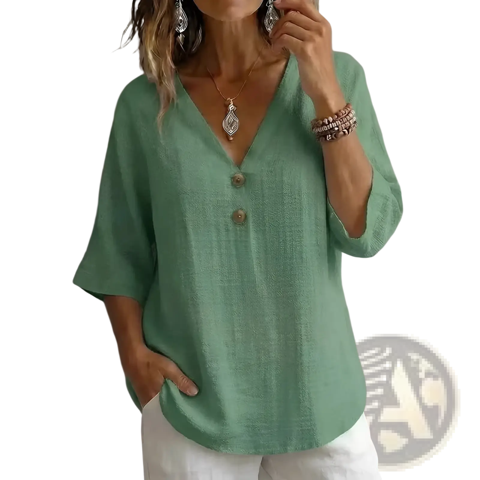 A soft sage green linen v-neck button top with three-quarter sleeves ideal for casual wear