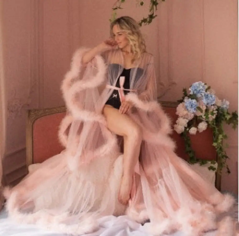 Luxurious blush pink tulle bridal robe with sheer overlay and fluffy feather trim for elegant nightwear