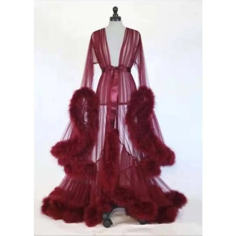 A flowing deep burgundy sheer tulle bridal robe with feathered ruffles and a satin sash for luxurious wear