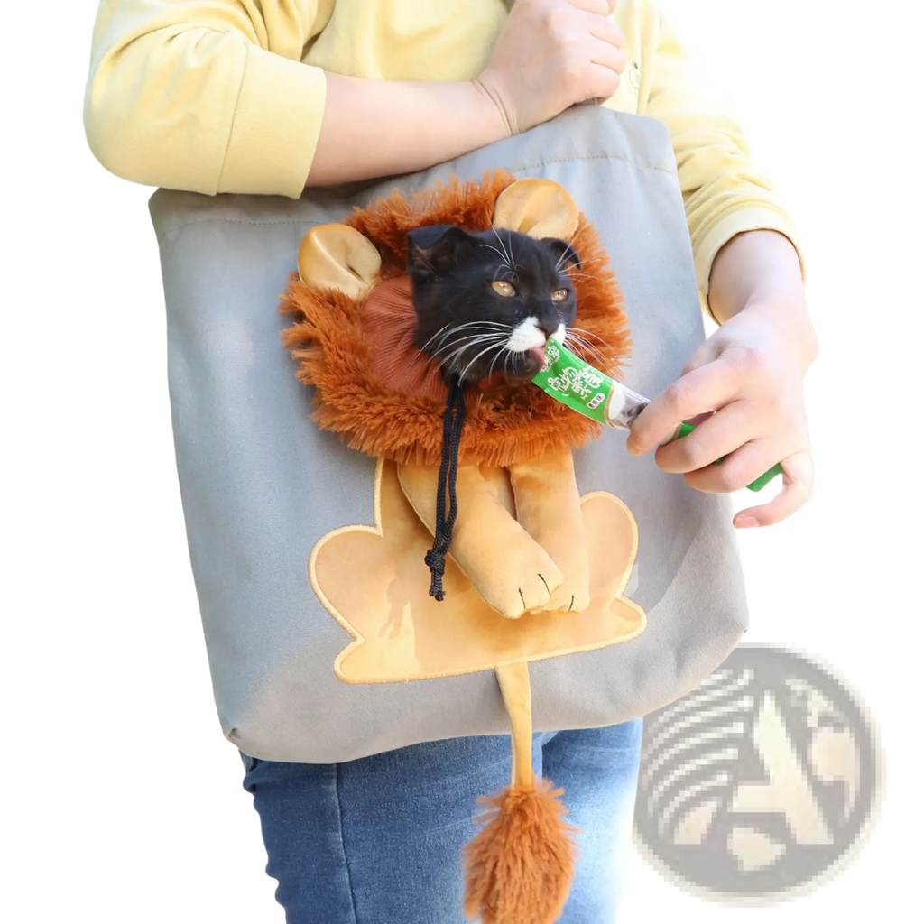 A black cat in a lion design portable pet carrier bag made of gray fabric with orange fur costume peek inside