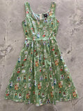 Little Women green vintage fit and flare sleeveless cotton dress with playful cartoon indoor scene pattern and pockets
