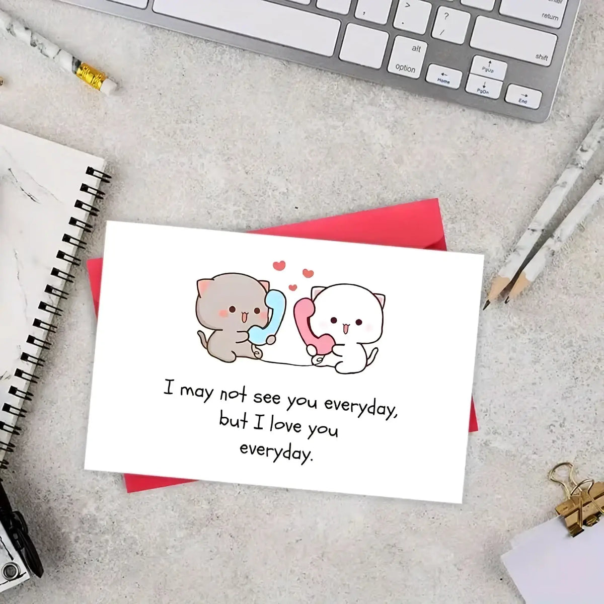 White long distance cat couple greeting card with two cartoon cats holding colorful phones and a love message