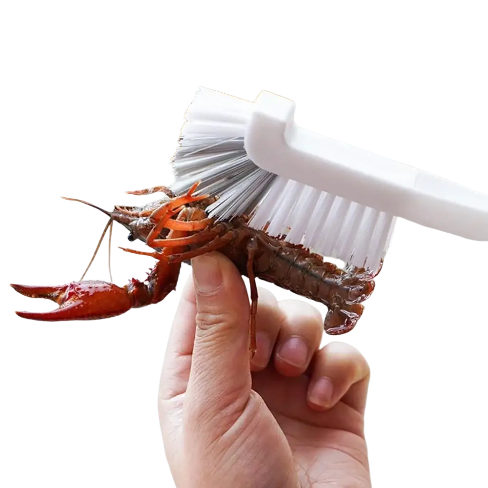 White plastic long handle bottle and dish scrub brush with white and gray bristles cleaning cooked red crawfish