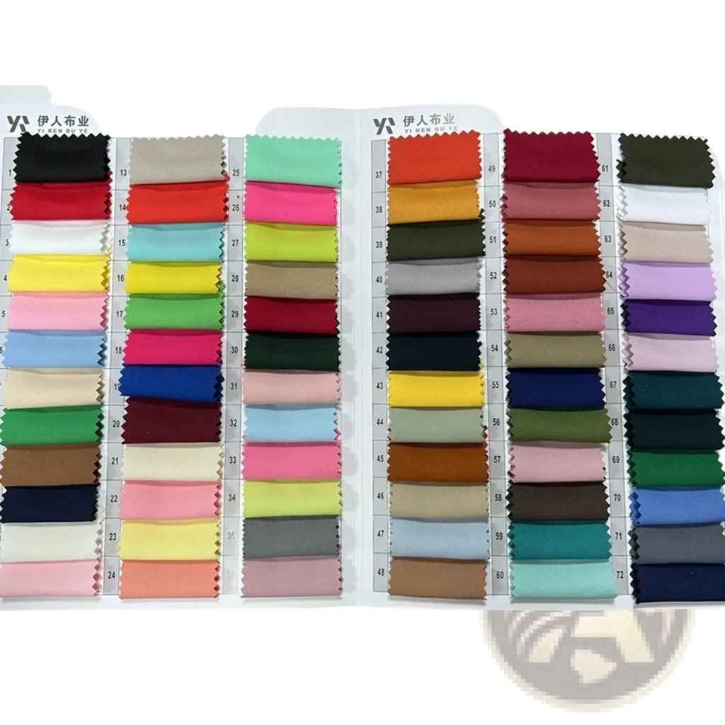 A long white blazer with black trim formal coat accompanied by a vibrant fabric swatch booklet with colorful textile samples