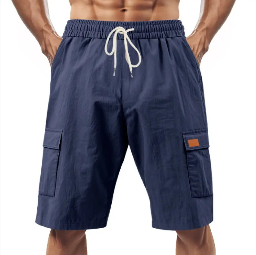 Men’s relaxed linen cargo drawstring shorts in navy blue with white drawstring and brown leather patch accents