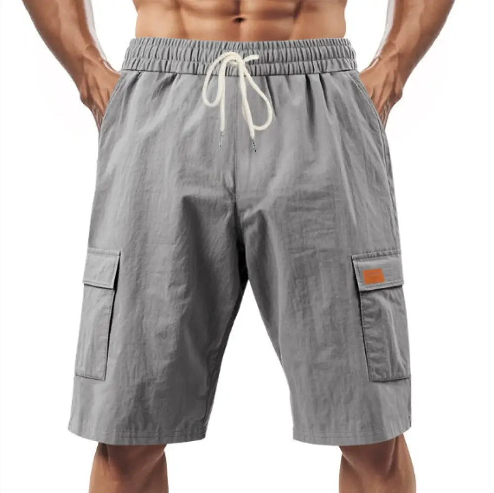 Men’s relaxed gray linen cargo shorts with white drawstring waistband and orange patch pockets for casual wear