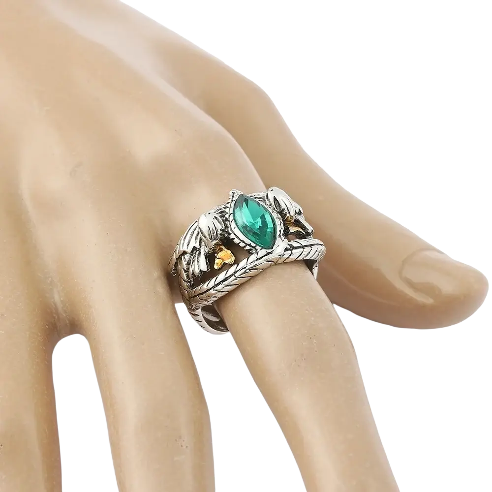 Silver-toned lord ring of barahir featuring an intricate braided design with central emerald-cut green crystal and gold accents