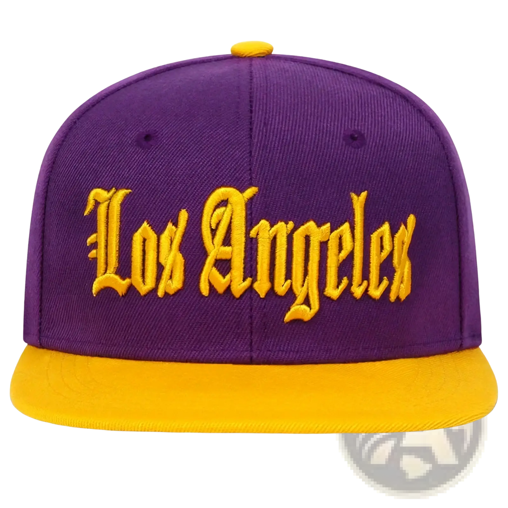 Purple and gold snapback cap with los angeles embroidered in yellow script on the front panel