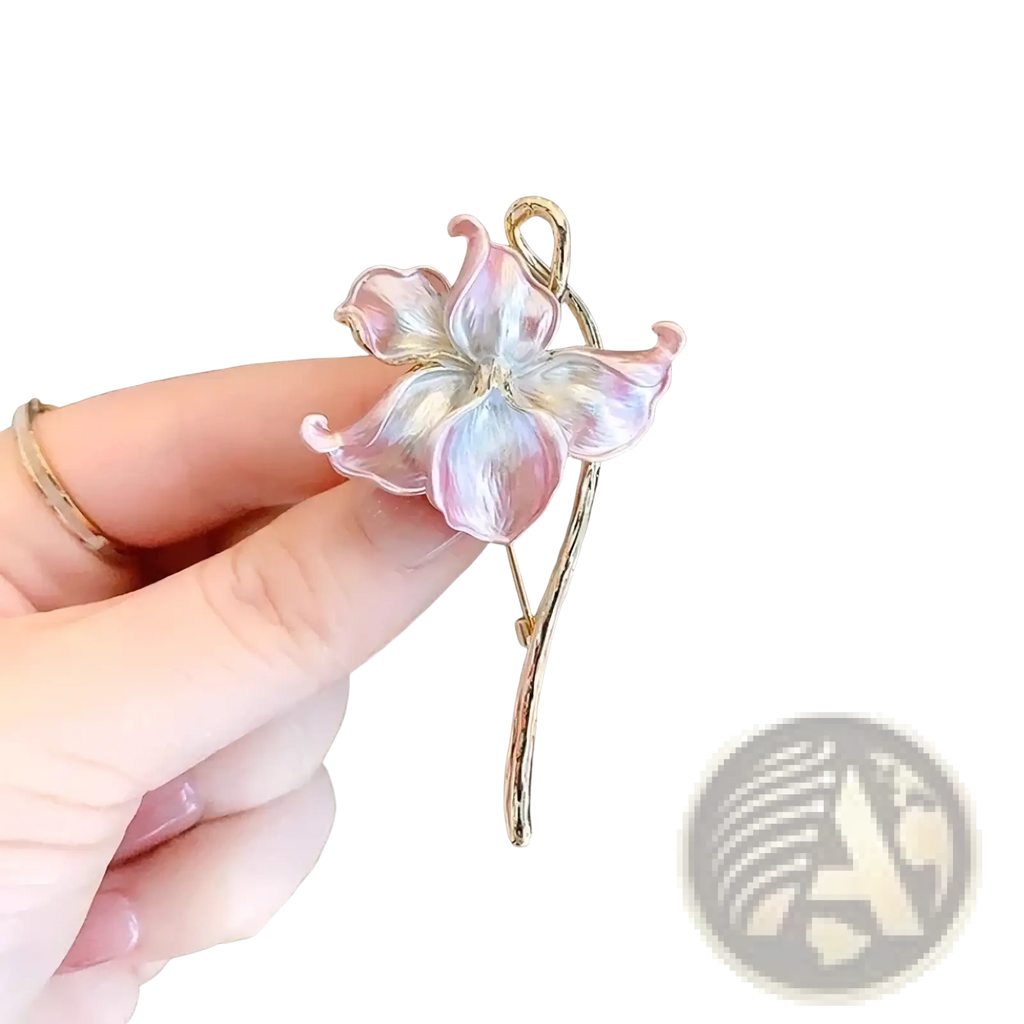 Lotus flower enamel brooch pin with delicate pink translucent petals and gold-tone stem and leaf catching the light