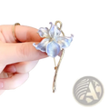 Lotus flower enamel brooch pin with delicate light blue translucent petals and gold-toned stem and pin