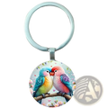 A round colorful glass dome lovebird keychain featuring two affectionate birds on a floral branch with hearts