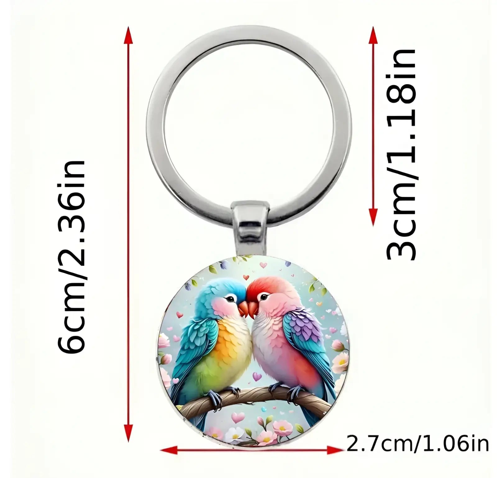 A lovebird keychain featuring a colorful illustration under a clear glass dome with a silver metal ring