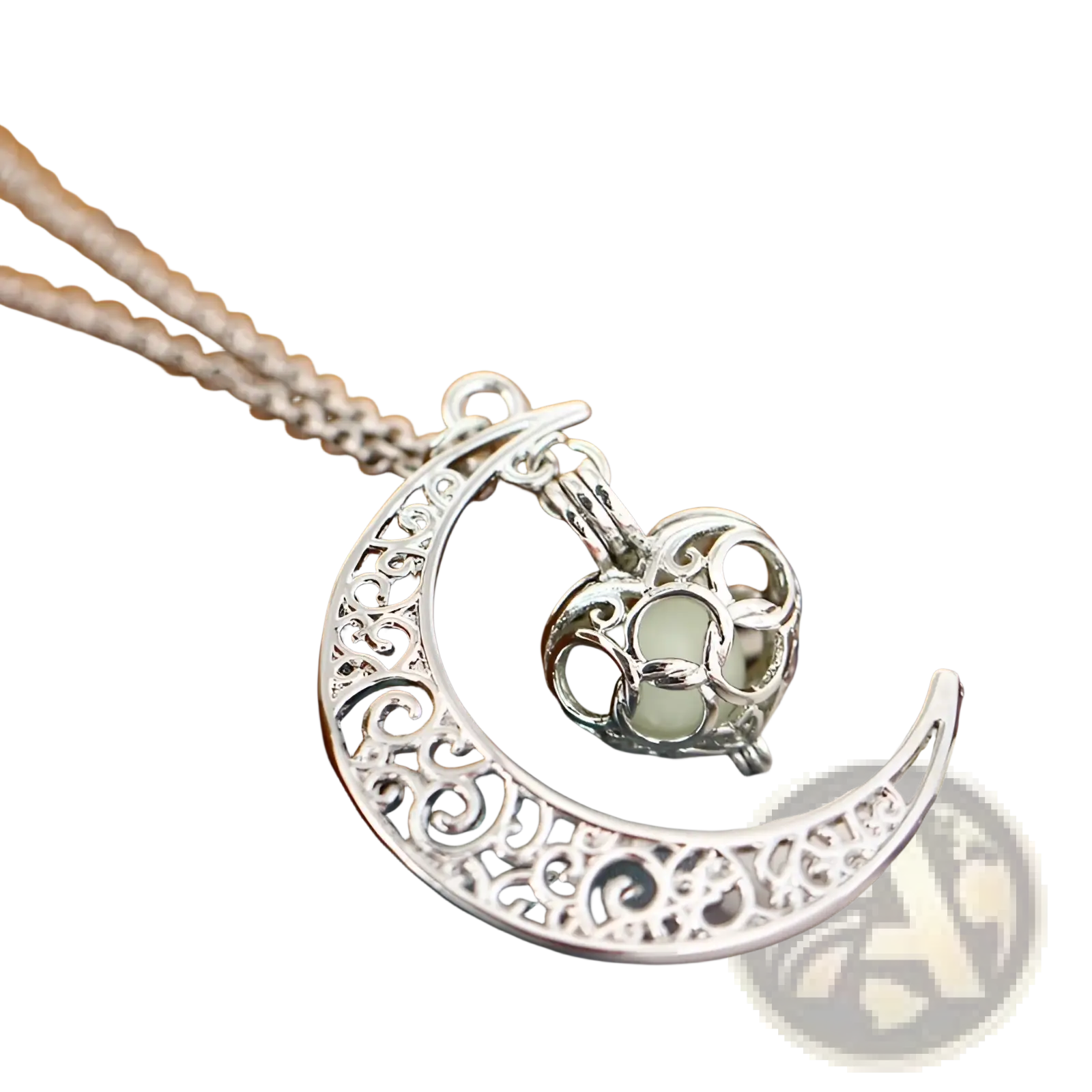 Silver crescent moon pendant necklace with intricate filigree design and a glowing heart-shaped locket charm