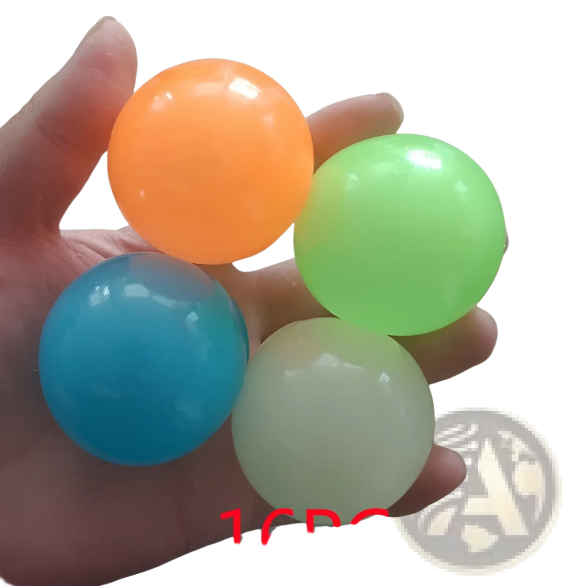 A hand holds four colorful translucent luminous sticky wall balls glow in the dark squeeze toy in orange green blue and white