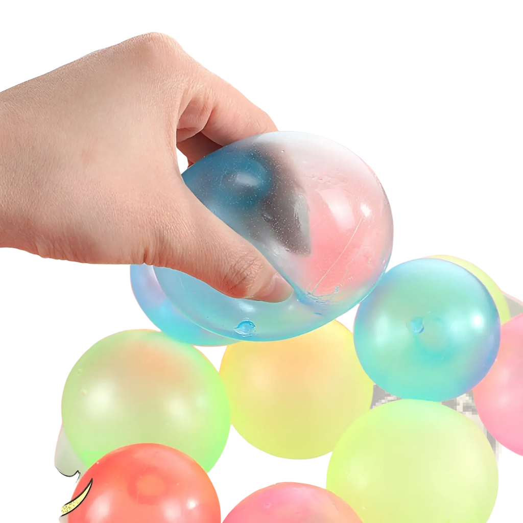 A translucent blue and pink luminous sticky wall ball with a glossy squishy texture glow in the dark squeeze toy