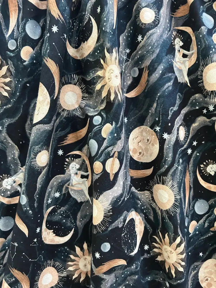 Dark luna celestial print cotton 1950s vintage midi dress with golden suns moons and ethereal figures on night sky