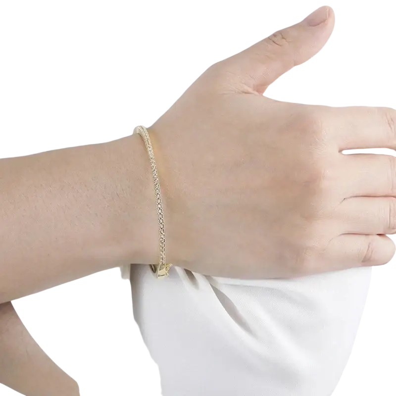 A luxury gold plated bangle bracelet with a delicate gold toned chain and small elegant clasp featuring cubic zirconia