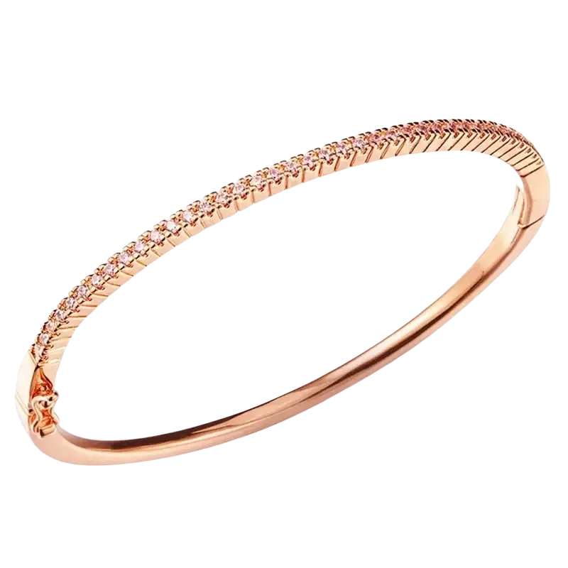 Luxury gold plated bangle bracelet in rose gold with hinged design and sparkling pink cubic zirconia along textured edge