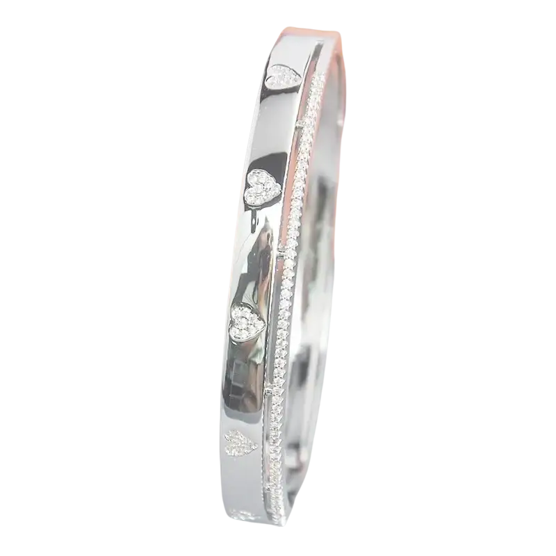 Silver bangle bracelet with heart-shaped diamonds and pave stones in luxury gold plated cubic zirconia design