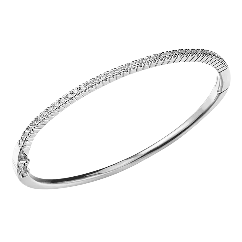 A sleek silver luxury gold plated bangle bracelet with sparkling cubic zirconia along its textured ridged surface
