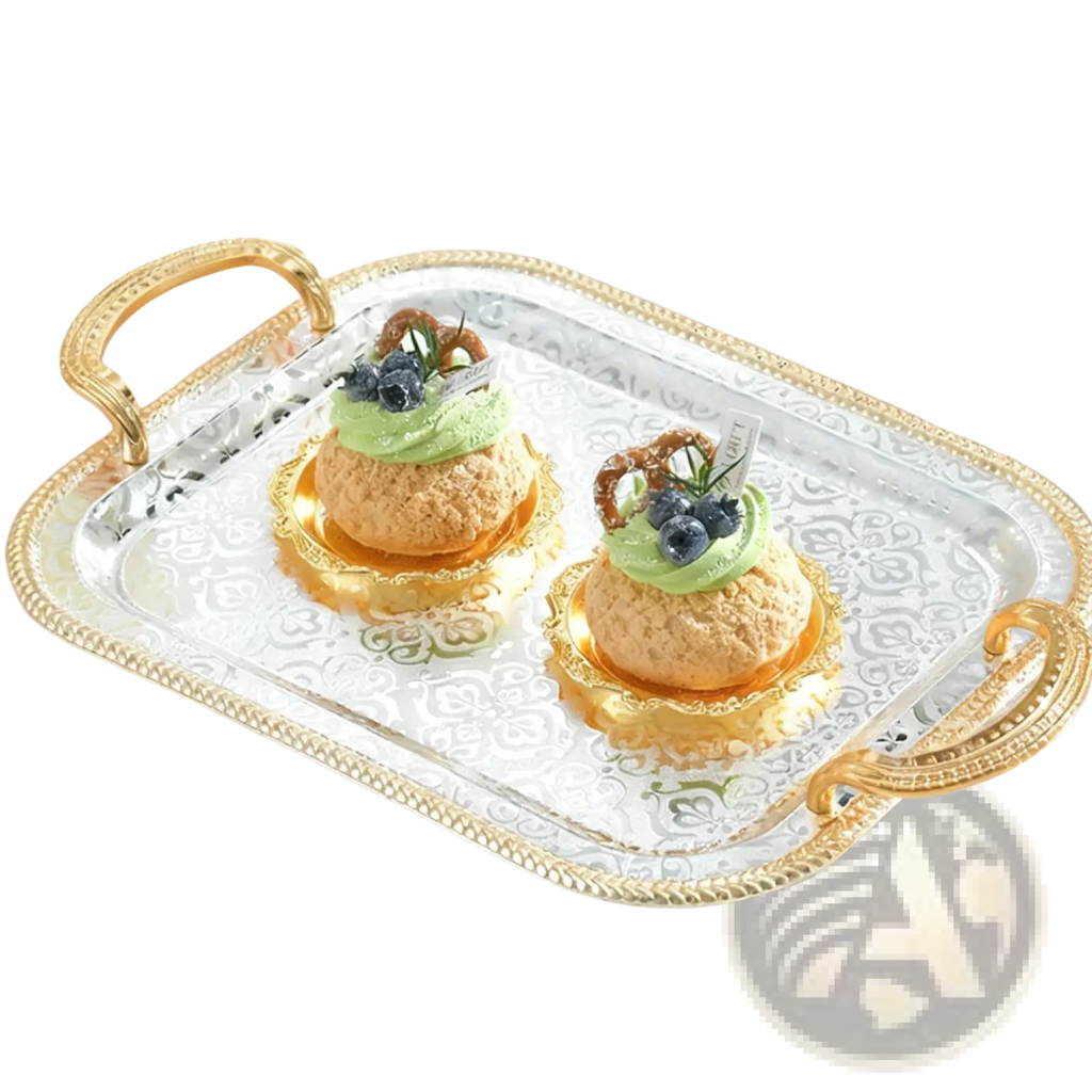 Luxury rectangle serving tray in silver with ornate gold handles and embossed pattern holding green-frosted pastries