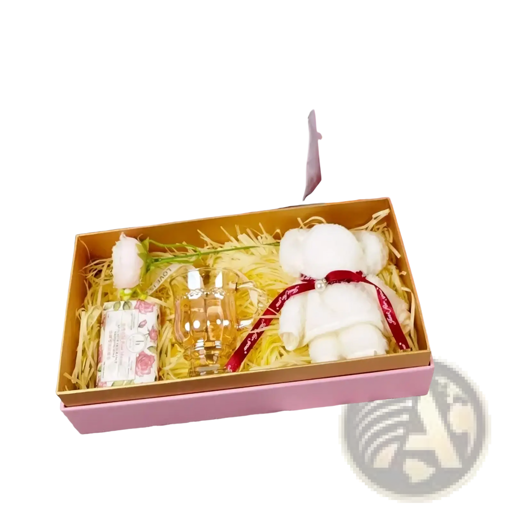 A plush white teddy bear with a red ribbon and diamond embellishment in a luxury wedding gift box for bridesmaid and best man