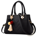 Luxury women handbags black woven PU leather crossbody bag with gold-tone hardware and decorative pom-pom tassel charm