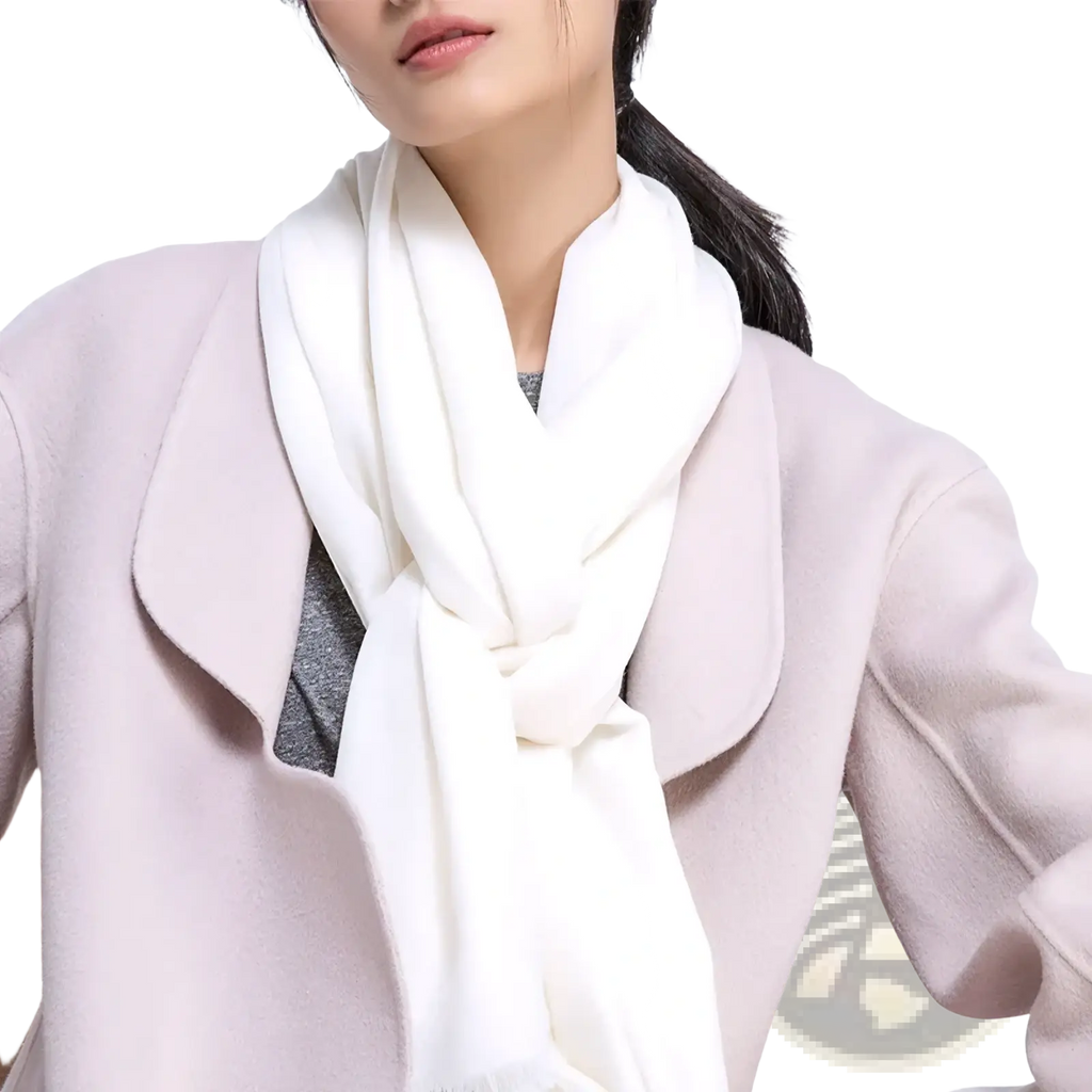 A soft off-white cashmere luxury wool scarf for women elegantly draped around the neck