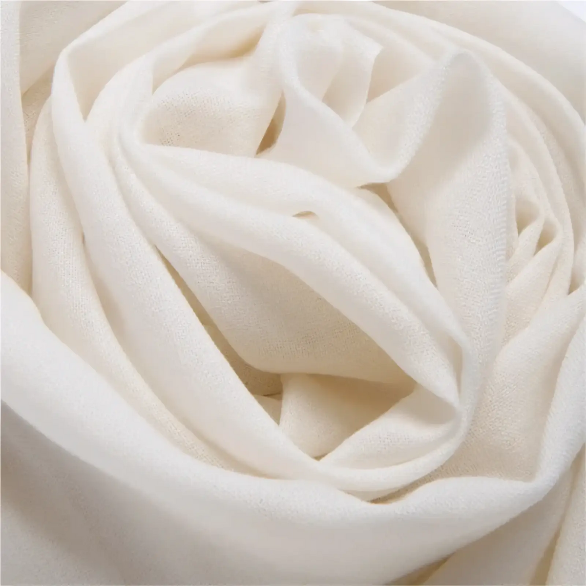 Luxury wool scarf for women in soft off-white silk elegantly folded into a rose-like swirl