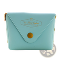 A light blue rectangular leather and pvc clutch purse with gold-tone button closure and embossed branding