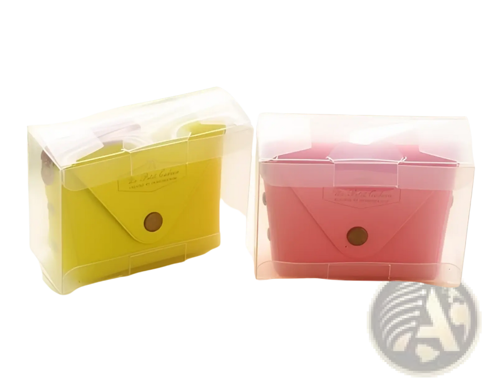Two translucent plastic coin purses in yellow and pink with white leather flaps and brown button closures
