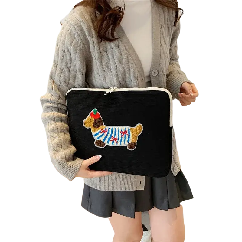 Black corduroy macbook pro laptop sleeve with a colorful embroidered dachshund wearing striped clothing and a red hat