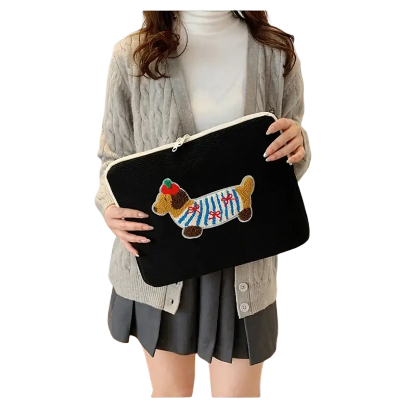 Black corduroy MacBook Pro laptop sleeve embroidered with a colorful dachshund design and blue white stripes