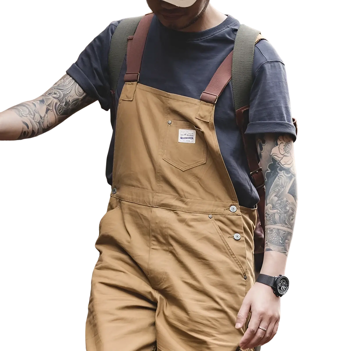 Maden vintage tan canvas workwear overalls made of cotton with brown leather straps and a white label on the chest pocket