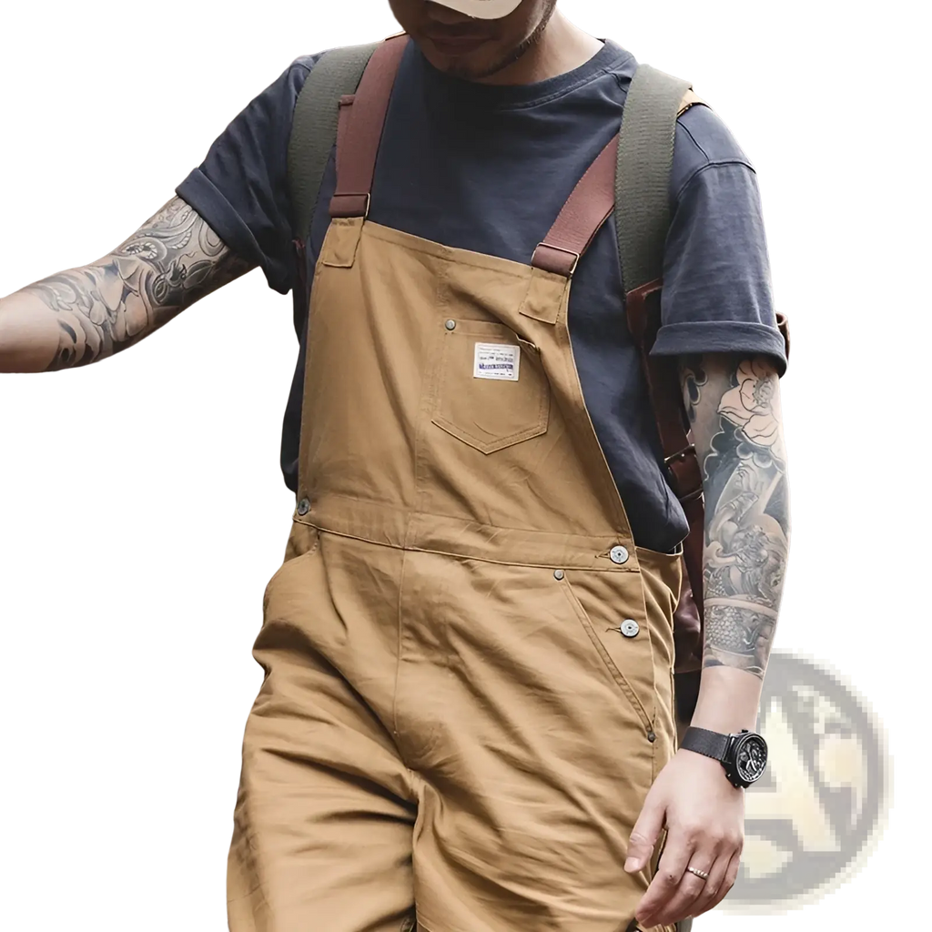 Maden vintage tan canvas workwear overalls made of cotton with brown leather straps and a white label on the chest pocket