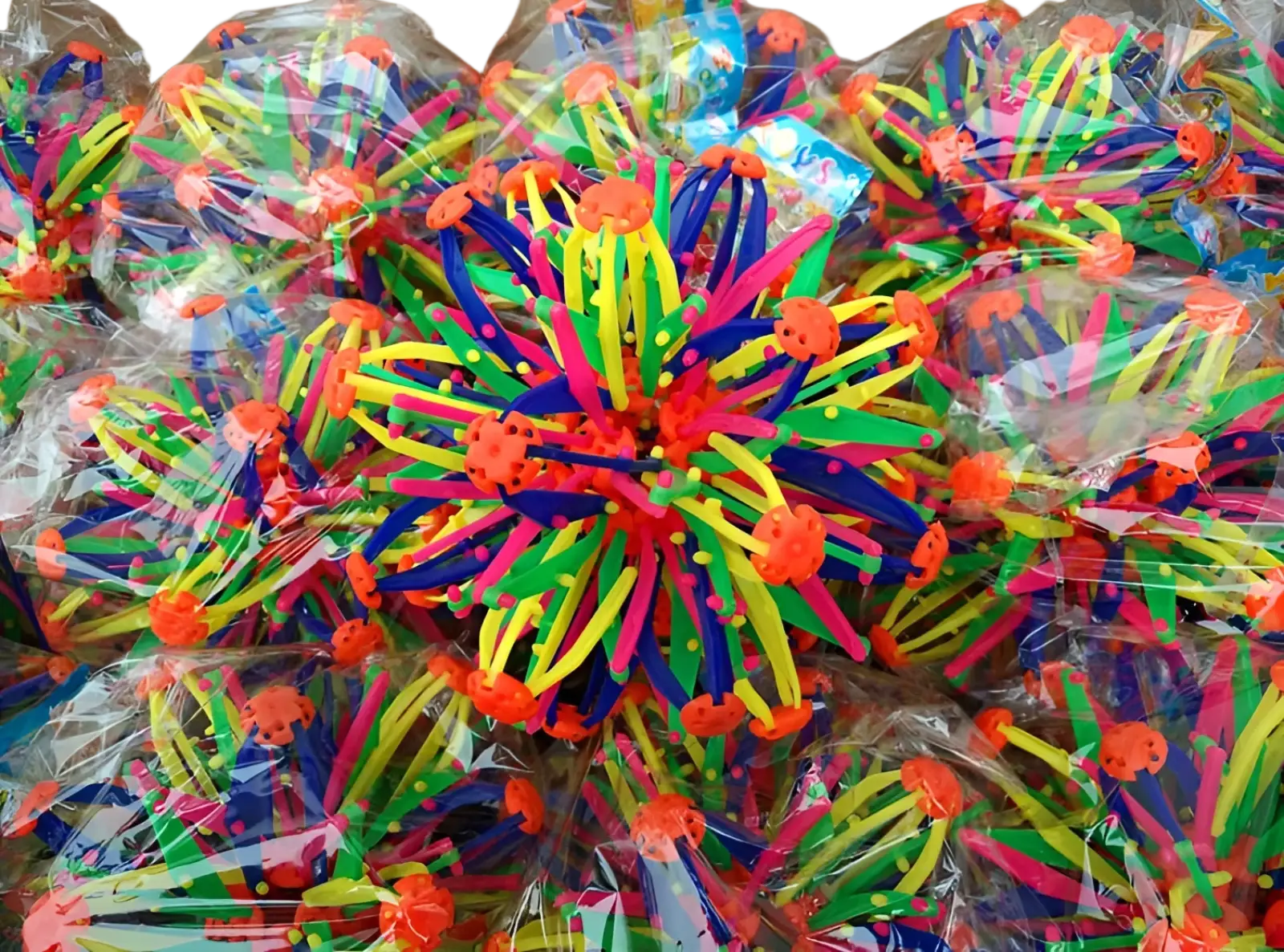 Vibrant multicolored plastic spiky magic expanding ball toy with orange crab-like tops and telescopic sphere design