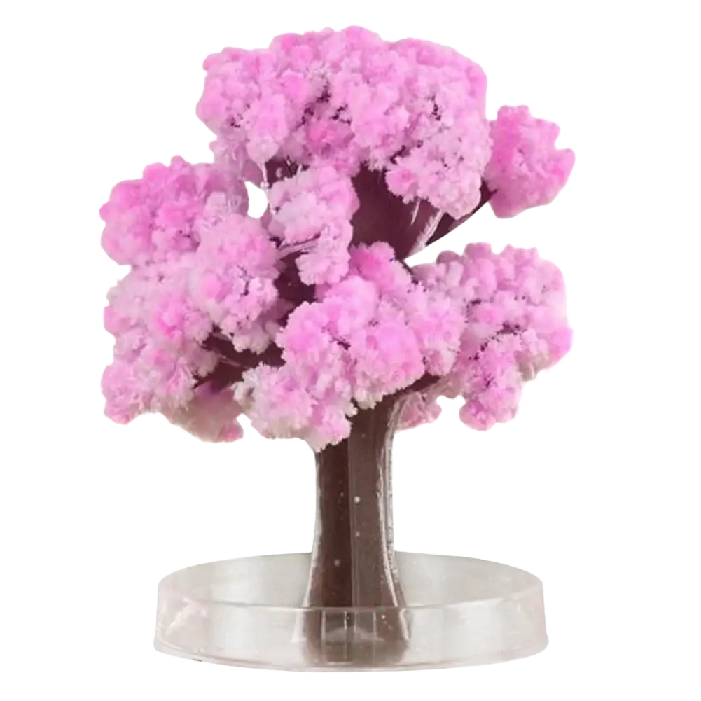 Magic growing Christmas tree crystal tabletop toy featuring a pink crystalline cherry blossom tree with dark brown trunk and transparent base