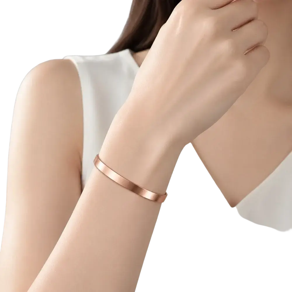 A sleek rose gold zinc alloy 1pc magnetic bangle bracelet with minimalist design worn on wrist