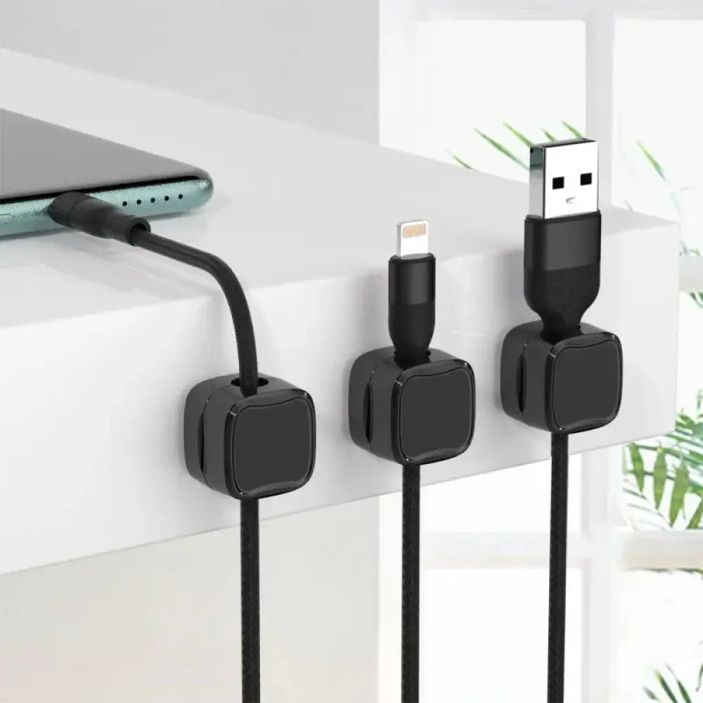 Black magnetic square under desk cable organizer with glossy plastic clips holding usb and lightning cables