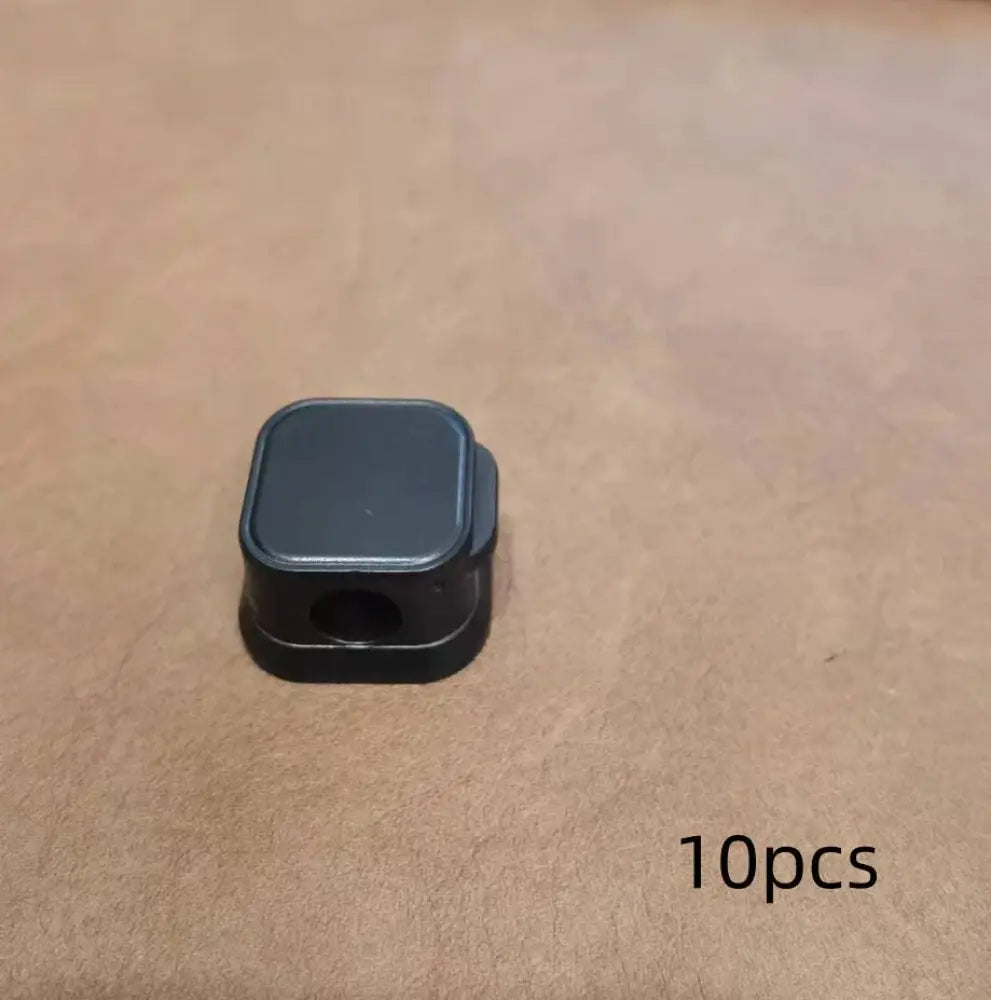 Black plastic magnetic square under desk cable organizer with circular hole camera mount adapter top visible