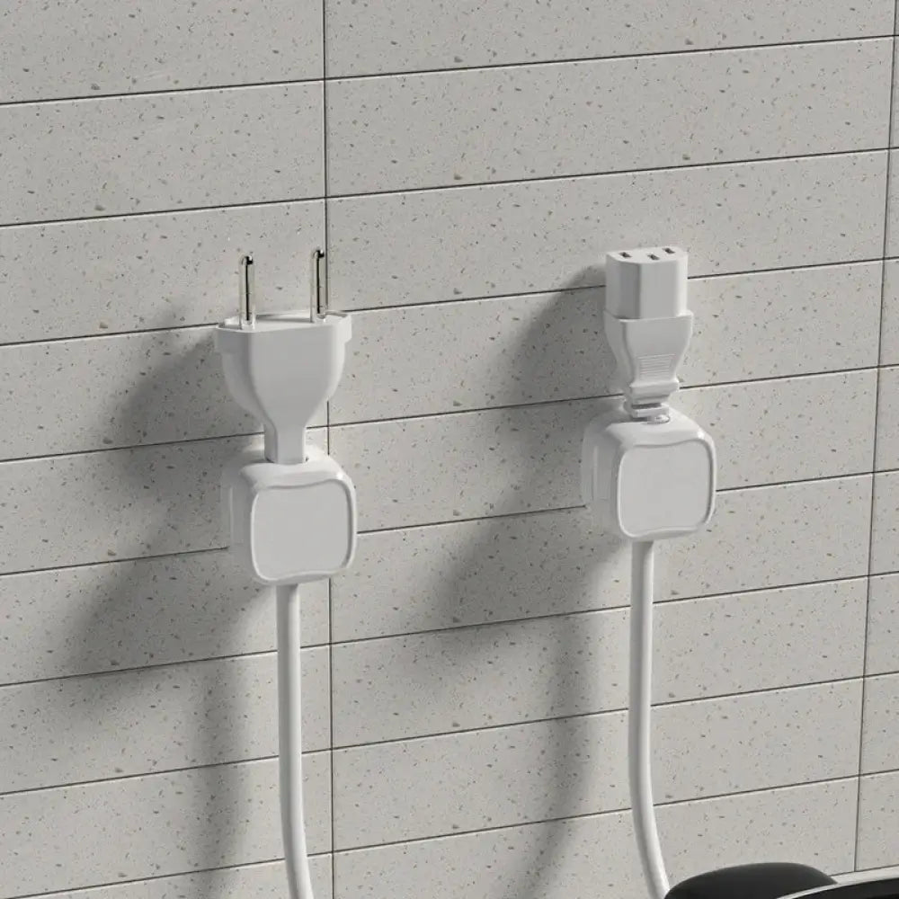 Two white minimalist wall-mounted power adapters with integrated cords for magnetic square under desk cable organizer